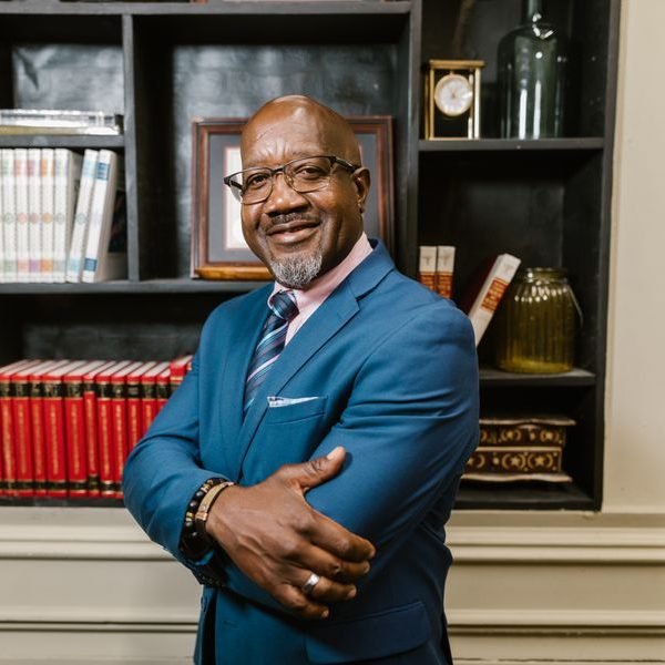 Portrait of a smiling businessman in a blue suit and glasses