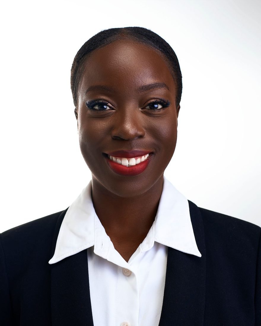 Portrait of a smiling woman in a dark blazer and white shirt